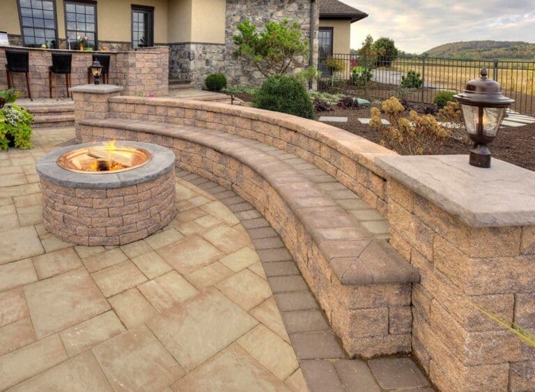 Fire pit with curved stone seating outdoor living space design, landscape architecture, backyard entertainment area, patio, fire feature, stonework, outdoor fireplace, scenic view.