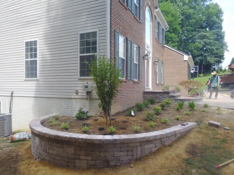 Lush backyard garden with brick retaining wall, ideal for outdoor living spaces and landscaping projects. Perfect for creating stylish outdoor environments and functional outdoor living areas.