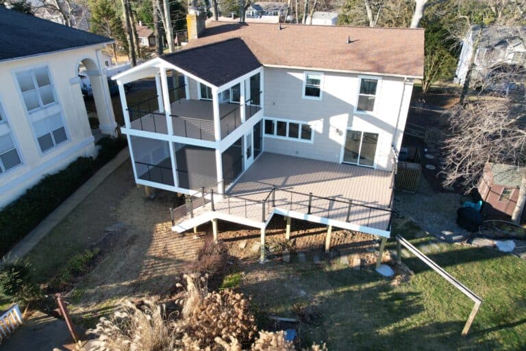 Spacious multi-level outdoor living space with decks and covered porch, perfect for entertaining and relaxation. Enhance your home's exterior with beautiful outdoor living spaces.