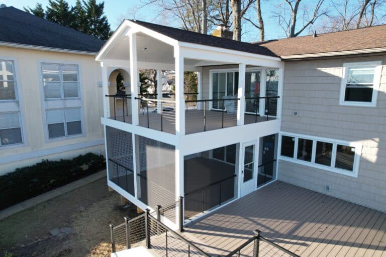 Modern outdoor living space with multi-level decks, stylish railings, and ample outdoor seating for entertaining and relaxation.