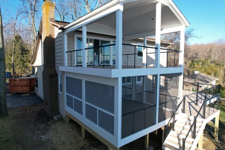Modern multi-level outdoor living space with spacious decks, stylish railings, and stairs, perfect for entertaining and relaxing in a beautiful backyard setting.
