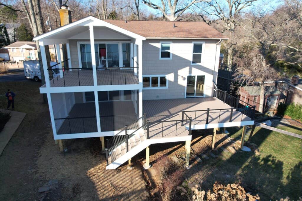Stunning multi-level outdoor living space with spacious decks and modern railings, perfect for entertaining and relaxing in a landscaped backyard.