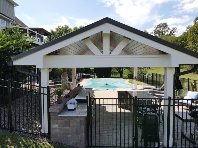 Beautiful outdoor living space featuring a covered pavilion with a perfect view of the backyard pool area, designed for outdoor entertainment and relaxation.