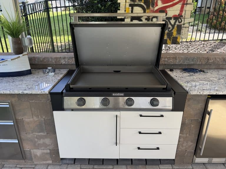 Grilling station with outdoor kitchen appliances, stainless steel grill, granite countertops, and outdoor storage for a stylish and functional outdoor living space.