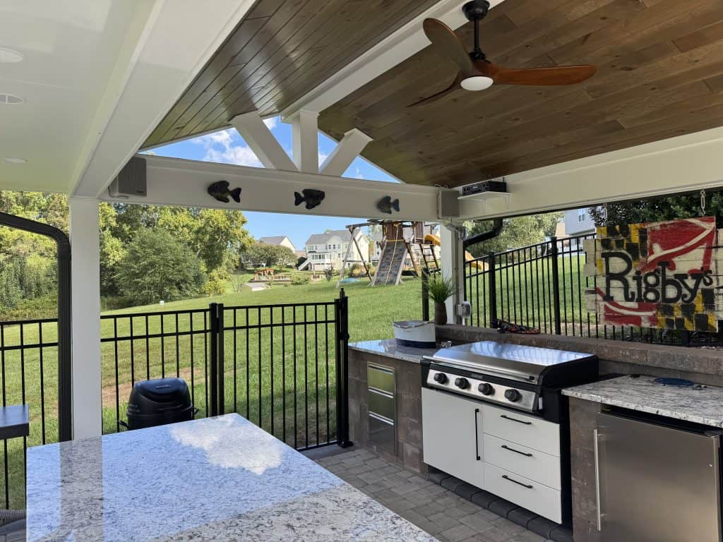 Elegant outdoor kitchen with grilling area and countertop, perfect for outdoor living and entertaining in a backyard Paradise.